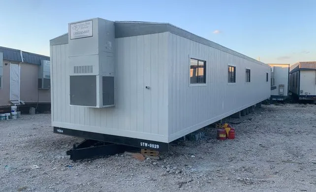 Site office trailer on a gravel jobsite with other trailers behind it